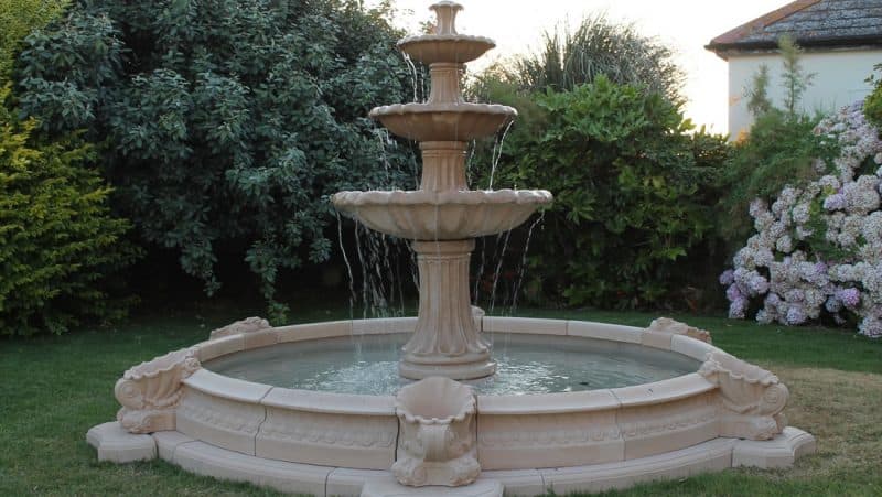 A premier fountain installed on its fibreglass pool base