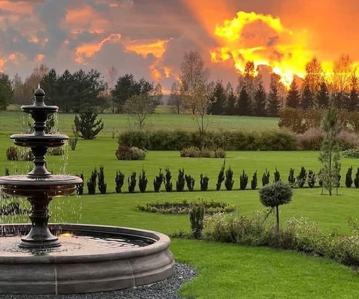 A traditional tiered stone fountain with a pool surround