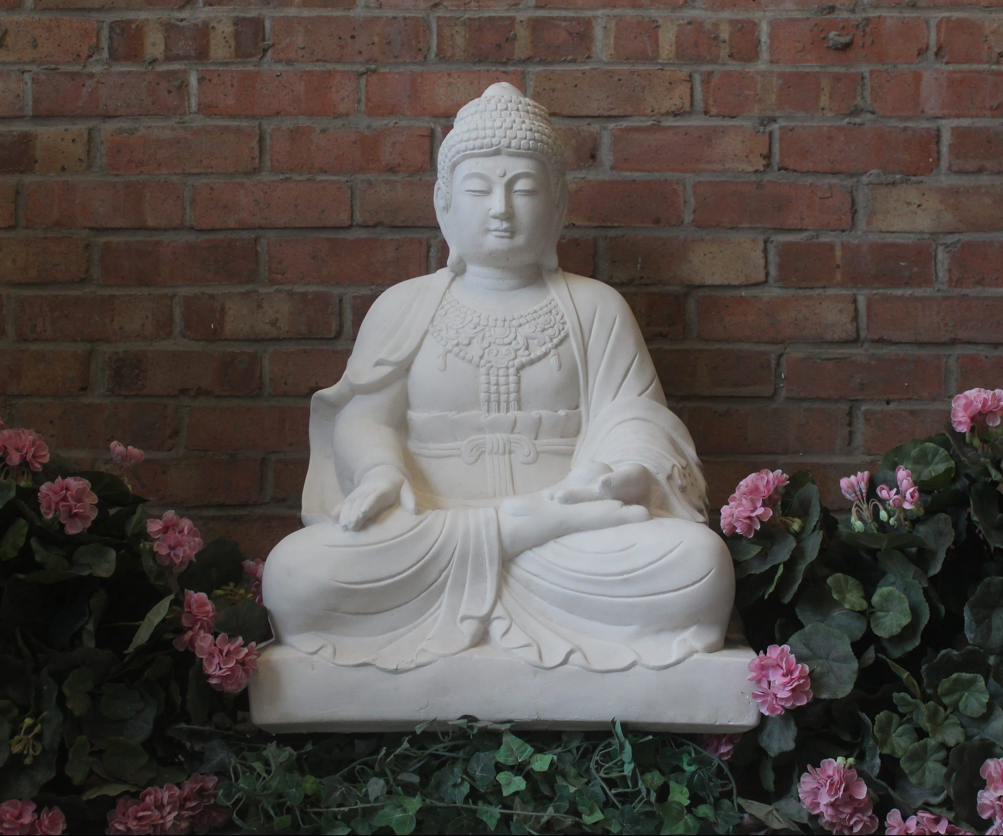 Extra Large Lotus Buddha statue seated in meditation in front of a brick wall