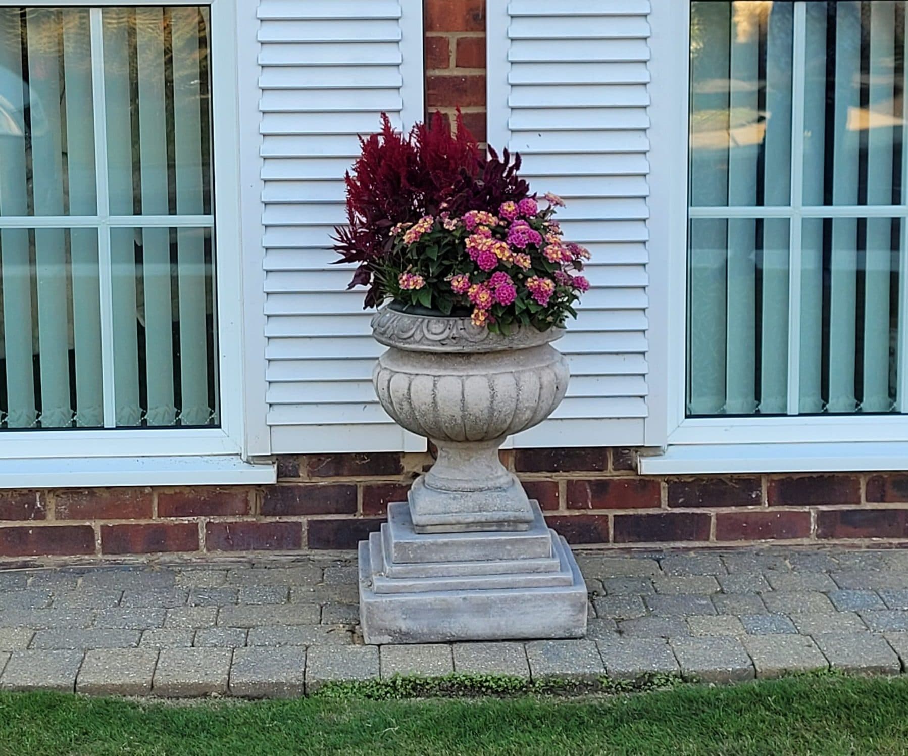 Pair of Danbury Urns on Regis Plinths