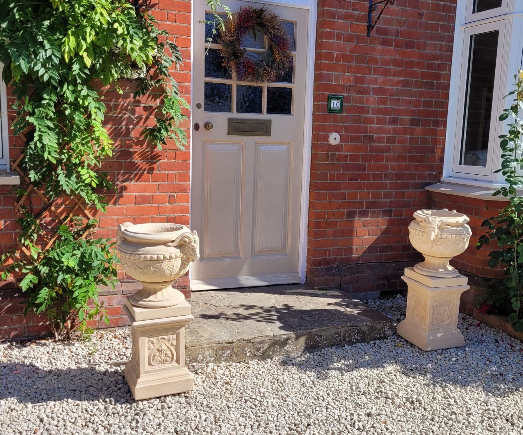 Pair of Rams Head Urns on Sherwood Plinths